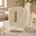White towel with 'Sharpee's' logo on a marble surface in a bathroom setting