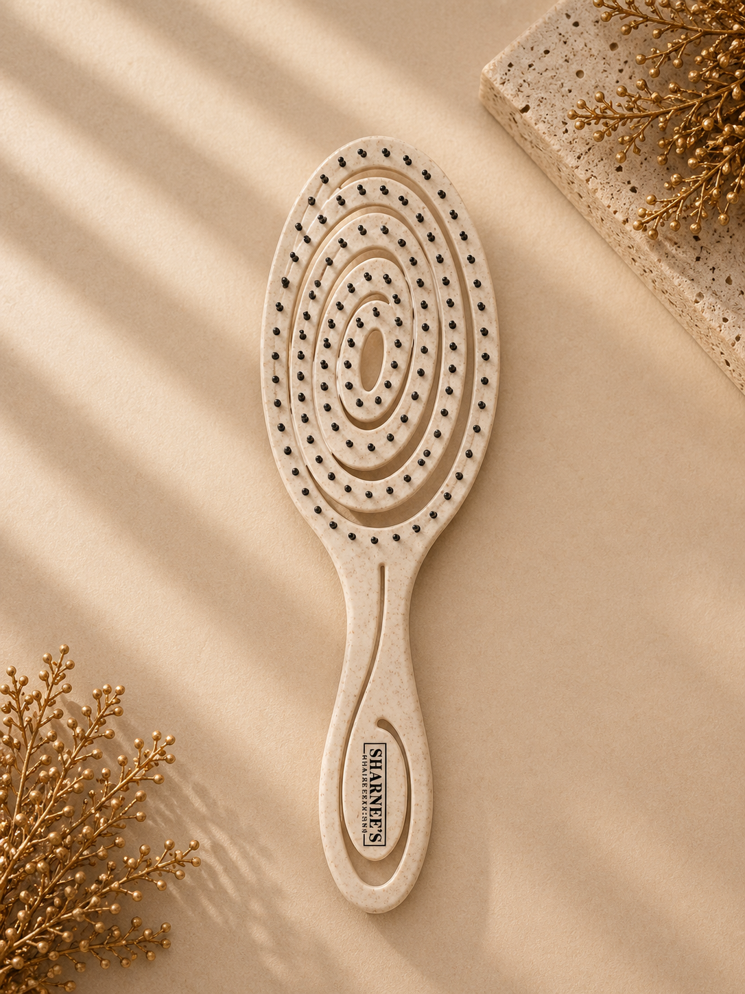 Wooden hairbrush with circular pattern on a beige background